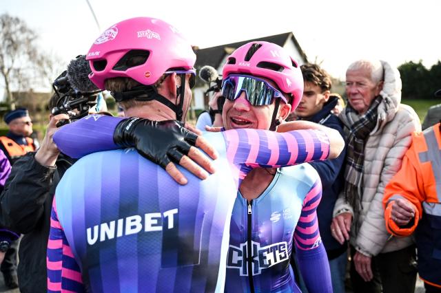 Unibet Rose Rockets' Dutch rider Dylan Groenewegen (R) celebrates with a teammate after winning the 'Bredene Koksijde Classic' one day cycling race, 203.4 km from Bredene to Koksijde, on March 20, 2026. (Photo by ELIAS ROM / Belga / AFP) / Belgium OUT