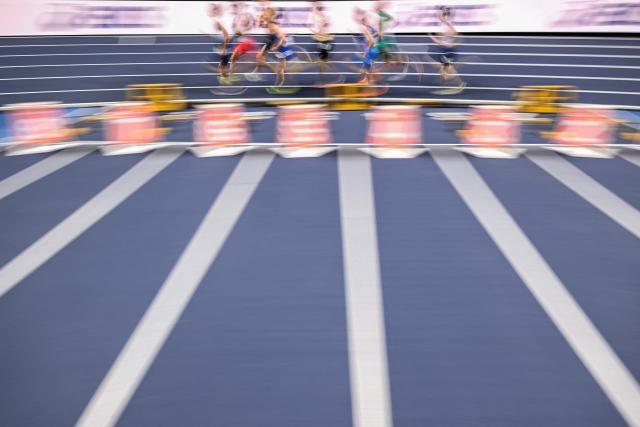 This slow shutter photograph shows athletes competing in the men's 1500 metres heat 1 during the World Athletics Indoor Championships Kujawy Pomorze 2026 in Torun, Poland on March 20, 2026. (Photo by Kirill KUDRYAVTSEV / AFP)