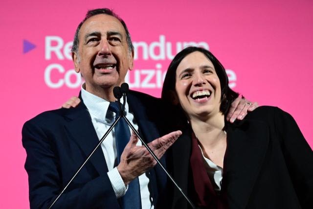 Elly Schlein, Secretary of Italian Democratic Party (PD) stands on stage with Milan's mayor Giuseppe Sala during a campaign meeting for the "NO" ahead of the Italian referendum on Justice reform, in Milan on March 20, 2026. Italian citizens will vote on 22 and 23 March 2026, in a confirmatory referendum regarding a constitutional reform of the judicial system proposed by the government. The reform centers on the "separation of careers" between judges and public prosecutors. (Photo by Stefano Rellandini / AFP)