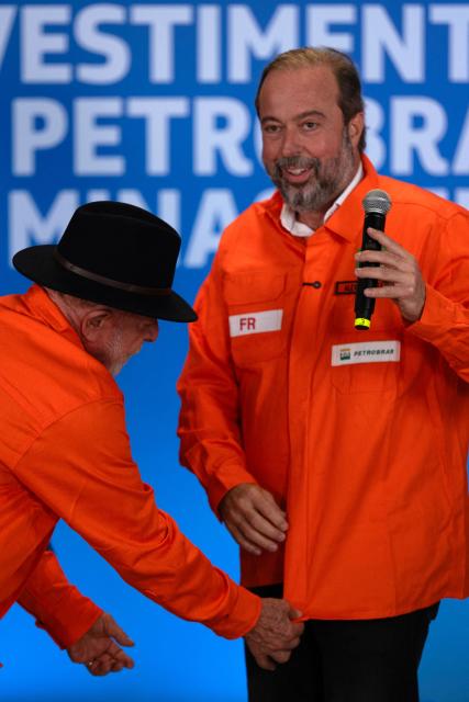 Brazil's President Luiz Inacio Lula da Silva (L) straigntens the shirt of his Minister of Mines and Energy, Alexandre Silveira as he speaks on Petrobras' investments at the Gabriel Passos Refinery in Betim, Minas Gerais state, Brazil, on March 20, 2026. (Photo by Douglas MAGNO / AFP)