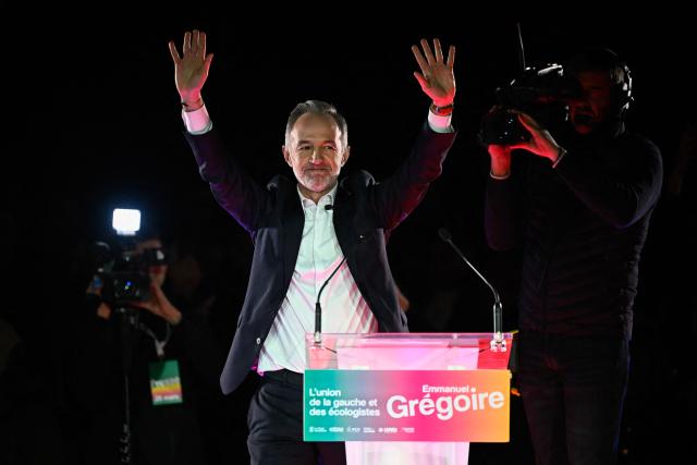 French Socialist Party (PS) Member of Parliament and left wing candidate for the Paris city hall Emmanuel Gregoire waves to supporters during a campaign rally ahead of the second round of France's 2026 municipal elections, at the Belleville Park in Paris on March 20, 2026. French voters head to the polls on March 22, 2026, for the second round of municipal elections. (Photo by JULIEN DE ROSA / AFP)