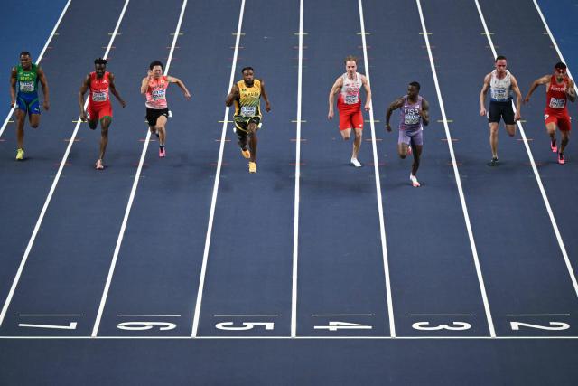 (L to R) Brazil's Erik Cardoso, Cameroon's Claude Itoungue Bogognie, Japan's Yoshiki Kinashi, Jamaica's Kishane Thompson, Poland's Oliwer Wdowik, USA's Trayvon Bromell, Italy's Samuele Ceccarelliand Puerto Rico's Eloy Benitez compete in the men's 60 metres semi-final heat 2 during the World Athletics Indoor Championships Kujawy Pomorze 2026 in Torun, Poland on March 20, 2026. (Photo by Andrej ISAKOVIC / AFP)