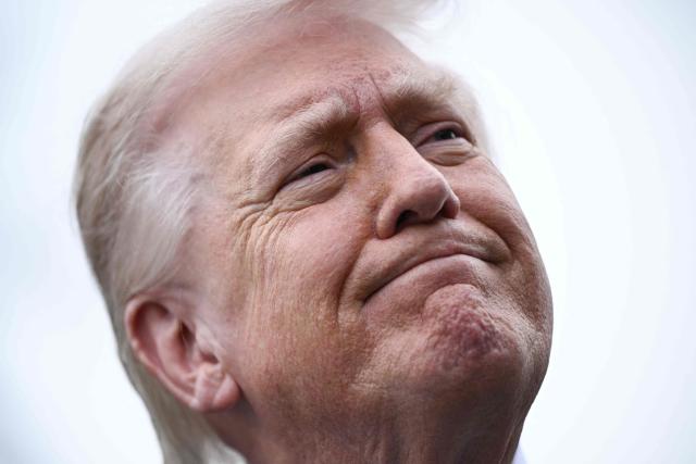 US President Donald Trump speaks to journalists before boarding Marine One as he departs from the South Lawn of the White House in Washington, DC, on March 20, 2026 for his Mar-a-Lago residence, where he will spend the weekend. (Photo by Brendan SMIALOWSKI / AFP)