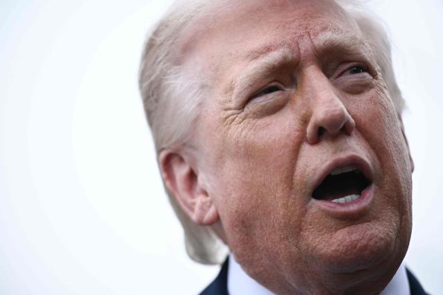 US President Donald Trump speaks to journalists before boarding Marine One as he departs from the South Lawn of the White House in Washington, DC, on March 20, 2026 for his Mar-a-Lago residence, where he will spend the weekend. (Photo by Brendan SMIALOWSKI / AFP)