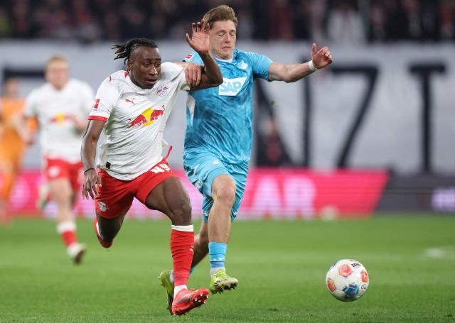 Leipzig's Ivorian forward #49 Yan Diomande (L) and Hoffenheim's Austrian midfielder #22 Alexander Prass vie for the ball during the German first division Bundesliga football match between RB Leipzig and TSG 1899 Hoffenheim in Leipzig, eastern Germany, on March 20, 2026. (Photo by Ronny HARTMANN / AFP) / DFL REGULATIONS PROHIBIT ANY USE OF PHOTOGRAPHS AS IMAGE SEQUENCES AND/OR QUASI-VIDEO
