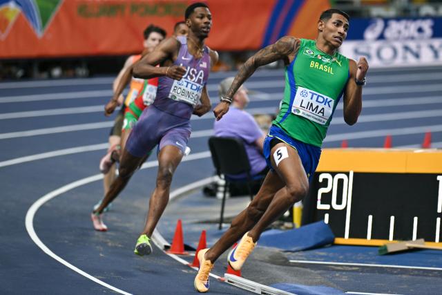Brazil's Matheus Lima (R) and USA's Chris Robinson (L) compete in the men's 400 metres semi-final heat 1 during the World Athletics Indoor Championships Kujawy Pomorze 2026 in Torun, Poland on March 20, 2026. (Photo by Andrej ISAKOVIC / AFP)