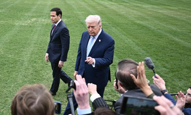 US Secretary of State Marco Rubio looks on as US President Donald Trump speaks to journalists before boarding Marine One as he departs from the South Lawn of the White House in Washington, DC, on March 20, 2026 for his Mar-a-Lago residence, where he will spend the weekend. (Photo by Brendan SMIALOWSKI / AFP)