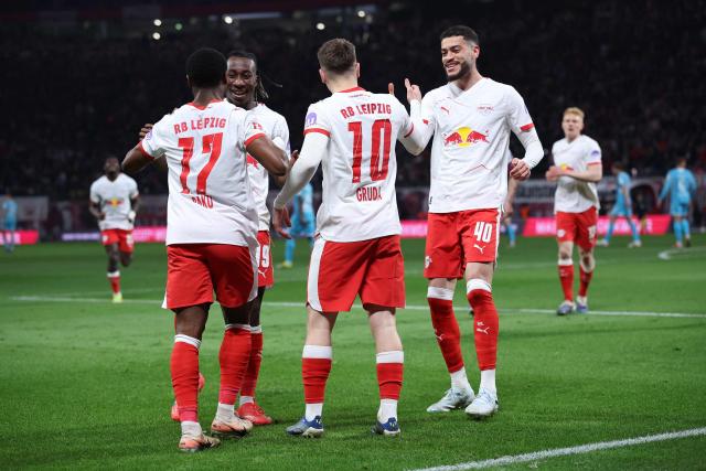 Leipzig's German midfielder #10 Brajan Gruda celebrates scoring the opening goal with his teammates during the German first division Bundesliga football match between RB Leipzig and TSG 1899 Hoffenheim in Leipzig, eastern Germany, on March 20, 2026. (Photo by Ronny HARTMANN / AFP) / DFL REGULATIONS PROHIBIT ANY USE OF PHOTOGRAPHS AS IMAGE SEQUENCES AND/OR QUASI-VIDEO