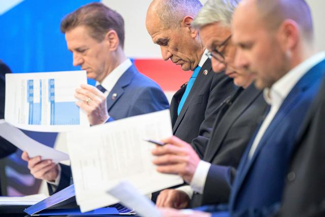 (From L) Slovenia's Prime Minister Robert Golob, Slovenia's opposition leader and nationalist former Prime Minister Janez Jansa, Slovenia's Minister of Economy, Tourism and Sport Matjaz Han and leader of the Christian Democrats conservative party Jernej Vrtovec prepare for the last televised political debate in Ljubljana on March 20, 2026, ahead of the parliamentary elections. Slovenians voters are scheduled to head to the polls on March 22, 2026. (Photo by Jure Makovec / AFP)
