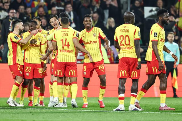 Lens' French forward #10 Florian Thauvin (4thL) celebrates with his teammates after scoring his team's first goal during the French L1 football match between RC Lens and SCO Angers at the Stade Bollaert-Delelis in Lens, northern France, on March 20, 2026. (Photo by Sameer Al-DOUMY / AFP)