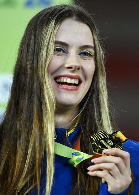 Gold medallist Ukraine's celebrates on the podium for the women's high jump event of the World Athletics Indoor Championships Kujawy Pomorze 2026 in Torun, Poland on March 20, 2026. (Photo by Kirill KUDRYAVTSEV / AFP)