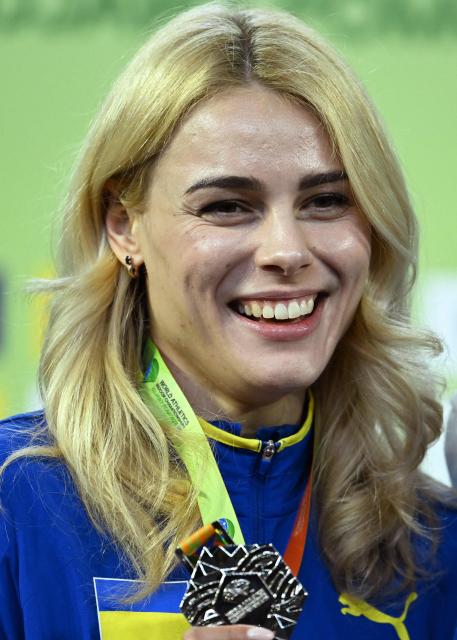 Silver medallist Ukraine's Yuliia Levchenko celebrates on the podium for the women's high jump event of the World Athletics Indoor Championships Kujawy Pomorze 2026 in Torun, Poland on March 20, 2026. (Photo by Kirill KUDRYAVTSEV / AFP)