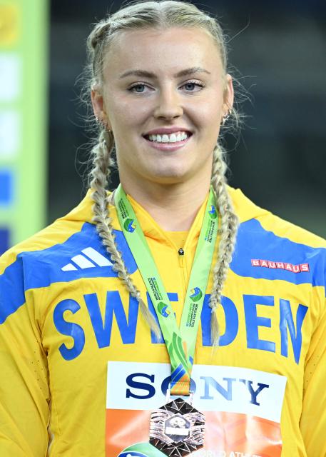 Bronze medallist Sweden's Axelina Johansson celebrates on the podium for the women's shot put event of the World Athletics Indoor Championships Kujawy Pomorze 2026 in Torun, Poland on March 20, 2026. (Photo by Kirill KUDRYAVTSEV / AFP)
