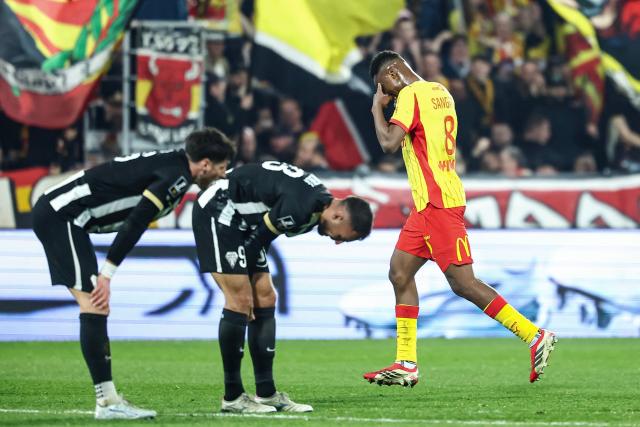 Lens' Malian midfielder #08 Mamadou Sangare (R) celebrates scoring his team's third goal as Angers' players react during the French L1 football match between RC Lens and SCO Angers at the Stade Bollaert-Delelis in Lens, northern France, on March 20, 2026. (Photo by Sameer Al-DOUMY / AFP)
