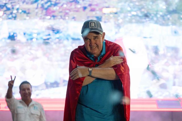 (FILES) Peru's presidential candidate Rafael Lopez Aliaga, for the Renovacion Popular party, gestures during a rally in the San Juan de Lurigancho district on the outskirts of Lima on March 15, 2026. Prisons surrounded by snakes, rewards for killing criminals, annihilation squads: in Peru, candidates in the April 12, 2026 presidential election are competing with proposals to curb rampant crime, marked by the rise of contract killings and extortion. (Photo by Ernesto BENAVIDES / AFP)