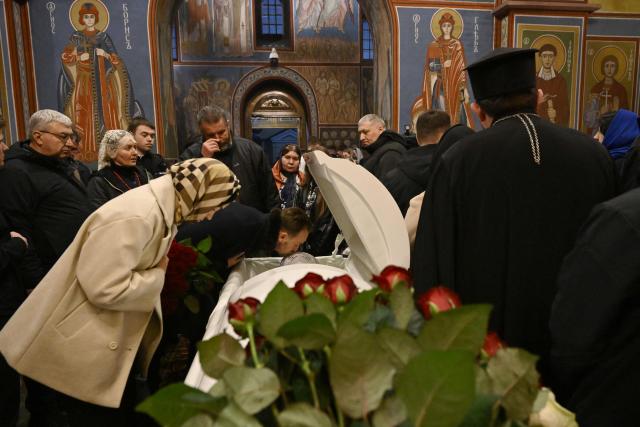 Clergymen and worshippers pay their last respects for the late Patriarch Filaret in St. Michael’s Golden-Domed Cathedral in Kyiv on March 20, 2026, amid the Russian invasion of Ukraine. Patriarch Filaret was a central player in establishing an independent Ukrainian Church in the 1990s, breaking from the Russian Church, which has become increasingly entwined with the Kremlin and supports Russia's war on Ukraine. (Photo by Genya SAVILOV / AFP)