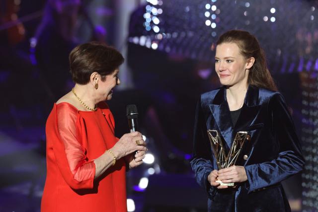 French percussionist Adelaide Ferriere (R) receives the Instrumental Soloist of the Year award from French actress Macha Méril during the Victoires de la Musique Classique 2026 music awards ceremony at Le Quartz theatre in Brest March 20, 2026. (Photo by FRED TANNEAU / AFP)