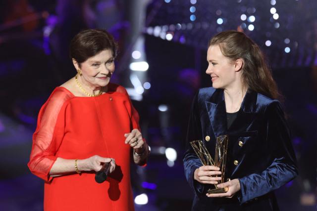 French percussionist Adelaide Ferriere (R) receives the Instrumental Soloist of the Year award from French actress Macha Méril during the Victoires de la Musique Classique 2026 music awards ceremony at Le Quartz theatre in Brest March 20, 2026. (Photo by FRED TANNEAU / AFP)