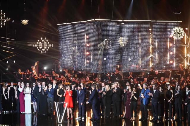 Masters of ceremony Belgian television host and comedian Alex Vizorek (centre R) and French TV personality Clément Rochefort (centre L) stand with award winners, nominees and ceremony performers at the end of the Victoires de la Musique Classique 2026 music awards ceremony at Le Quartz theatre in Brest March 20, 2026. (Photo by FRED TANNEAU / AFP)