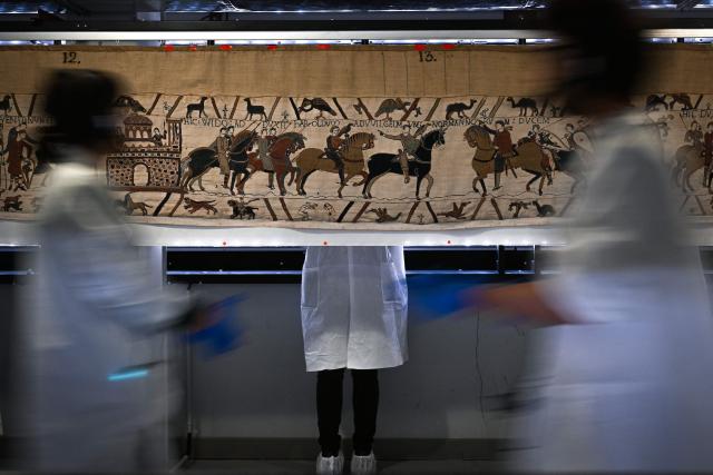(FILES) Workers and volunteers, rest before preparing to pack the Bayeux Tapestry in a crate for transfer to the British Museum, at the Bayeux Tapestry Museum, in Bayeux, northwestern France, on September 18, 2025. King Harold's legendary 200-mile march across England to the Battle of Hastings in 1066 is a "myth" that likely never happened, according to research published March 21, 2026. Ahead of the tapestry's exhibition at the British Museum starting in September 2026. New research from the University of East Anglia (UEA) revealed the account of the march as taught in British classrooms and museums, rests on what a UAE historian argues is a misinterpretation of the Anglo-Saxon Chronicle. (Photo by LOU BENOIST / POOL / AFP)