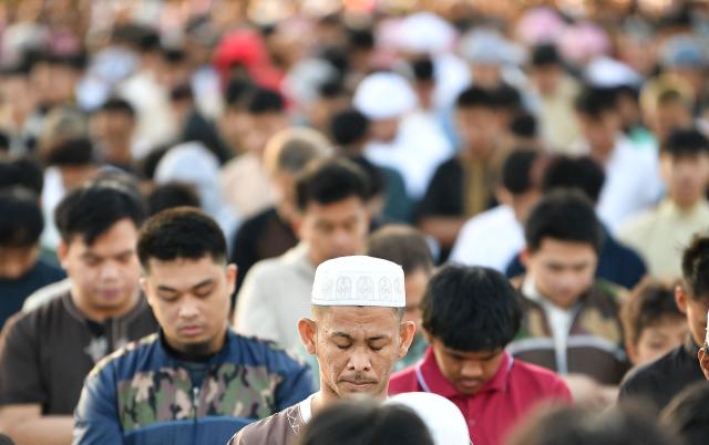Muslim devotees take part in a morning prayer celebrating Eid al-Fitr, which marks the end of the holy month of Ramadan, in front of the Quirino grandstand in Manila on March 21, 2026. (Photo by Ted ALJIBE / AFP)