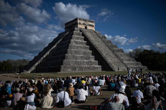 TOPSHOT - People gather to watch as the shape of a serpent is cast in shadows on the El Castillo pyramid in Chichen Itza on the day of the equinox, Yucatan State, Mexico, on March 20, 2026. The Chichen Itza equinox is a twice-yearly event (spring and fall) where sunlight and shadow create the illusion of a serpent, the deity Kukulcan on the world famous landmark, Chichen Itza’s main pyramid. (Photo by Carl de Souza / AFP)