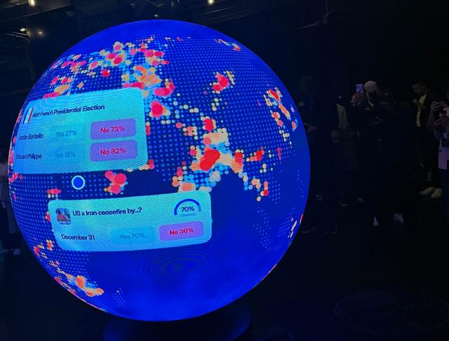 A LED sphere screen shows information inside the new location of the prediction market online platform Polymarket called "The Situation Room", during its opening day in Washington, DC, on March 20, 2026. Prediction market platforms have rapidly broken into the mainstream in the United States, positioning themselves as an alternative to both traditional polling and licensed sports betting. Platforms like Polymarket and its biggest rival Kalshi, remain illegal or unregulated in most countries outside the US, where regulators have generally classified them as unlicensed gambling. (Photo by Théo MARIE-COURTOIS / AFP)