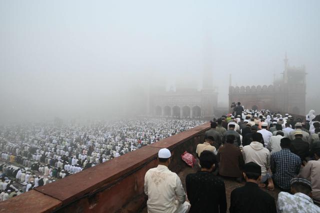 Muslim devotees attend Eid al-Fitr prayers, marking the end of the holy month of Ramadan, at Jama Masjid in the old quarters of new Delhi on March 21, 2026. (Photo by Arun SANKAR / AFP)