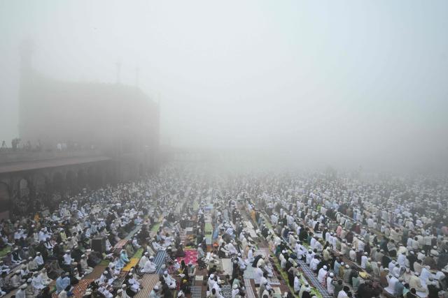 Muslim devotees attend Eid al-Fitr prayers, marking the end of the holy month of Ramadan, at Jama Masjid in the old quarters of new Delhi on March 21, 2026. (Photo by Arun SANKAR / AFP)