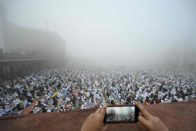 Muslim devotees attend Eid al-Fitr prayers, marking the end of the holy month of Ramadan, at Jama Masjid in the old quarters of new Delhi on March 21, 2026. (Photo by Arun SANKAR / AFP)
