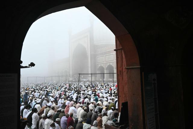 Muslim devotees attend Eid al-Fitr prayers, marking the end of the holy month of Ramadan, at Jama Masjid in the old quarters of new Delhi on March 21, 2026. (Photo by Arun SANKAR / AFP)