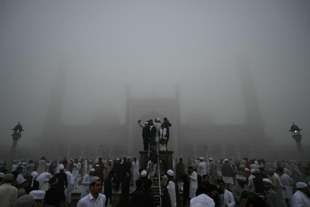 Muslim devotees celebrate after offering prayers, marking the end of the holy month of Ramadan, at Jama Masjid in the old quarters of new Delhi on March 21, 2026. (Photo by Arun SANKAR / AFP)