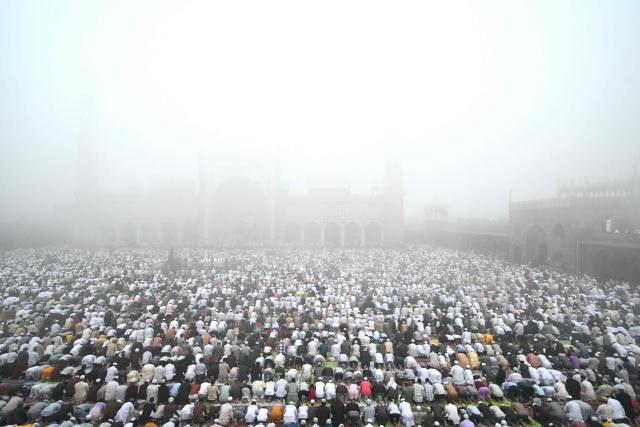 Muslim devotees attend Eid al-Fitr prayers, marking the end of the holy month of Ramadan, at Jama Masjid in the old quarters of new Delhi on March 21, 2026. (Photo by Arun SANKAR / AFP)