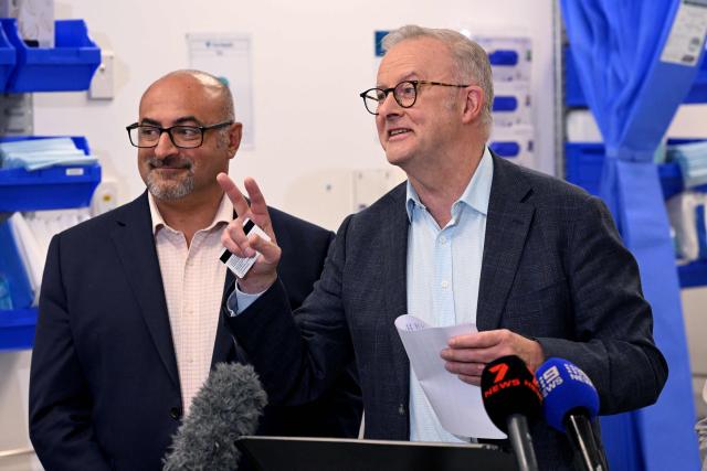 Australia's Prime Minister Anthony Albanese (R) speaks as local MP Peter Khalil (L) looks on during a press conference after the opening of a medical centre in the Melbourne suburb of Coburg on March 21, 2026. Albanese answered questions relating to the fuel crisis and comments by US President Trump. (Photo by William WEST / AFP)