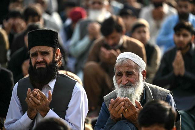 Muslim devotees offer Eid al-Fitr prayers, which marks the end of the Islamic holy fasting month of Ramadan, in Rawalpindi on March 21, 2026. (Photo by Farooq NAEEM / AFP)