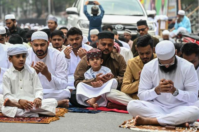 Muslim devotees offer Eid al-Fitr prayers, which marks the end of the Islamic holy fasting month of Ramadan, outside a mosque in Hyderabad on March 21, 2026. (Photo by Noah SEELAM / AFP)