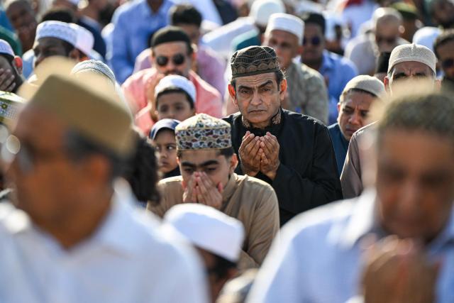 Muslim devotees offer Eid al-Fitr prayers, which marks the end of the Islamic holy fasting month of Ramadan, at Galle Face in Colombo on March 21, 2026. (Photo by Ishara S. KODIKARA / AFP)