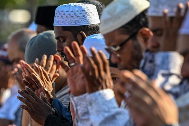 Muslim devotees offer Eid al-Fitr prayers, which marks the end of the Islamic holy fasting month of Ramadan, at Galle Face in Colombo on March 21, 2026. (Photo by Ishara S. KODIKARA / AFP)