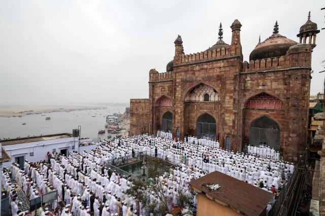 Muslim devotees offer Eid al-Fitr prayers, which marks the end of the Islamic holy fasting month of Ramadan, at Alamgir Mosque along the banks of the river Ganges in Varanasi on March 21, 2026. (Photo by Niharika KULKARNI / AFP)