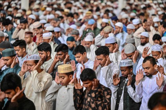 Muslim devotees offer Eid al-Fitr prayers, which marks the end of the Islamic holy fasting month of Ramadan, at the Baitul Mukarram National Mosque in Dhaka on March 21, 2026. (Photo by Munir UZ ZAMAN / AFP)