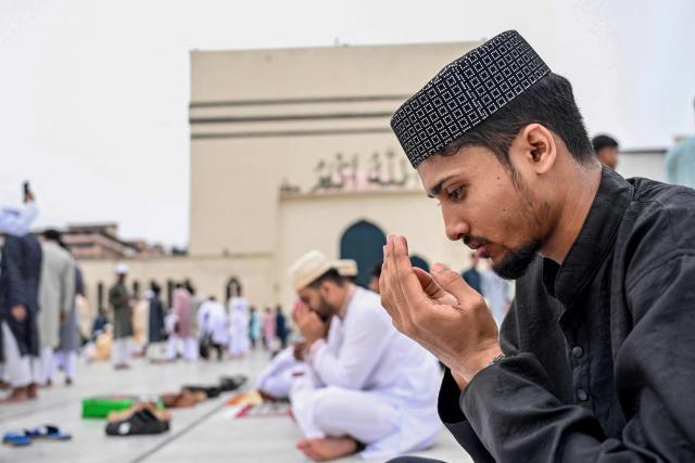A Muslim devotee offers Eid al-Fitr prayers, which marks the end of the Islamic holy fasting month of Ramadan, at the Baitul Mukarram National Mosque in Dhaka on March 21, 2026. (Photo by MUNIR UZ ZAMAN / AFP)