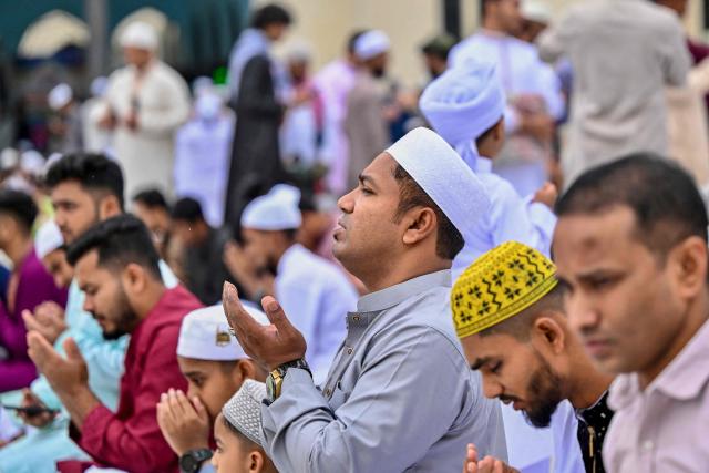 Muslim devotees offer Eid al-Fitr prayers, which marks the end of the Islamic holy fasting month of Ramadan, at the Baitul Mukarram National Mosque in Dhaka on March 21, 2026. (Photo by Munir UZ ZAMAN / AFP)