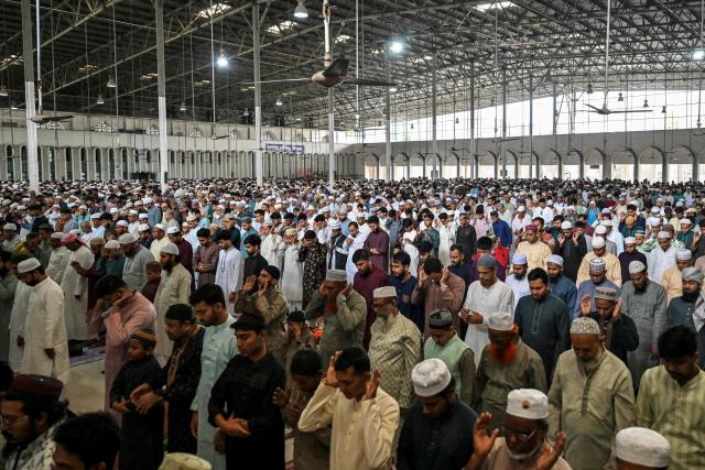 Muslim devotees offer Eid al-Fitr prayers, which marks the end of the Islamic holy fasting month of Ramadan, at the Baitul Mukarram National Mosque in Dhaka on March 21, 2026. (Photo by Munir UZ ZAMAN / AFP)