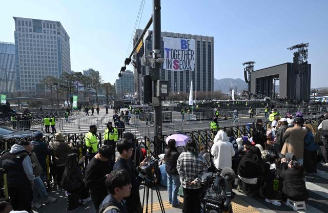 BTS fans arrive near the stage for the comeback concert of K-pop boy group BTS at Gwanghwamun Square in downtown Seoul on March 21, 2026. South Korean megastars BTS reunite on March 21, for their first show in nearly four years, with an expected 260,000 fans taking over central Seoul for a K-pop extravaganza livestreamed to millions more worldwide. (Photo by Jung Yeon-je / AFP)
