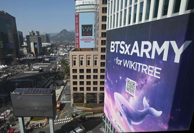 This general view shows the stage (L top) for the comeback concert of K-pop boy group BTS at Gwanghwamun Square in downtown Seoul on March 21, 2026. South Korean megastars BTS reunite on March 21, for their first show in nearly four years, with an expected 260,000 fans taking over central Seoul for a K-pop extravaganza livestreamed to millions more worldwide. (Photo by Jung Yeon-je / AFP)