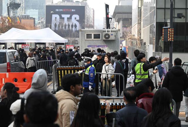 BTS fans arrive at the venue of the comeback concert of K-pop boy group BTS in downtown Seoul on March 21, 2026. South Korean megastars BTS reunite on March 21, for their first show in nearly four years, with an expected 260,000 fans taking over central Seoul for a K-pop extravaganza livestreamed to millions more worldwide. (Photo by Jung Yeon-je / AFP)
