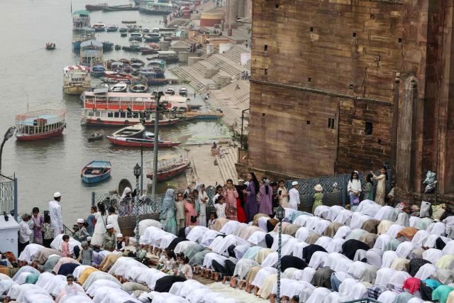 Muslim devotees offer Eid al-Fitr prayers, which marks the end of the Islamic holy fasting month of Ramadan, at Alamgir Mosque along the banks of the river Ganges in Varanasi on March 21, 2026. (Photo by Niharika KULKARNI / AFP)