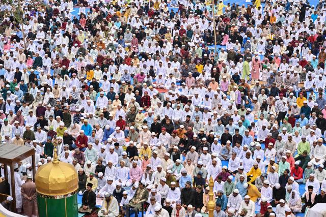 Muslim devotees offer Eid al-Fitr prayers, which marks the end of the Islamic holy fasting month of Ramadan, at the Idgah field in Guwahati on March 21, 2026. (Photo by Biju BORO / AFP)
