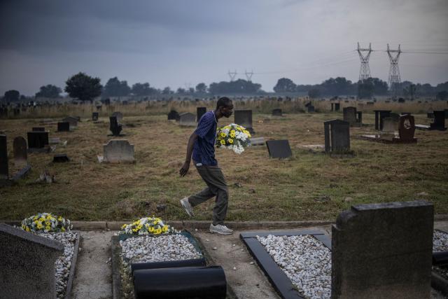 A member of the protocol carries flowers to the graves of the dozens killed on March 21, 1960 during what is remembered as the Sharpeville Massacre, at the Phelindaba Cemetery in Sharpeville, on March 21, 2026. The Sharpeville massacre occurred on 21 March 1960, when police opened fire on a crowd of people who had assembled outside the police station in the township of Sharpeville in the then Transvaal Province of the then Union of South Africa (today part of Gauteng) to protest against the pass laws. Today South Africa remembers the victims in what has become Human Rights Day. (Photo by MARCO LONGARI / AFP)