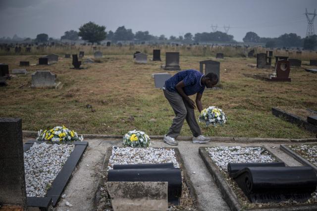 A member of the protocol deposes flowers on the graves of the dozens killed on March 21, 1960 during what is remembered as the Sharpeville Massacre, at the Phelindaba Cemetery in Sharpeville, on March 21, 2026. The Sharpeville massacre occurred on 21 March 1960, when police opened fire on a crowd of people who had assembled outside the police station in the township of Sharpeville in the then Transvaal Province of the then Union of South Africa (today part of Gauteng) to protest against the pass laws. Today South Africa remembers the victims in what has become Human Rights Day. (Photo by MARCO LONGARI / AFP)